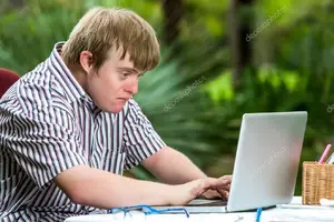 depositphotos_62329843-stock-photo-concentrated-handicapped-boy-typing-on.webp