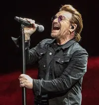 1200px-Bono_singing_in_Indianapolis_on_Joshua_Tree_Tour_2017_9-10-17.webp